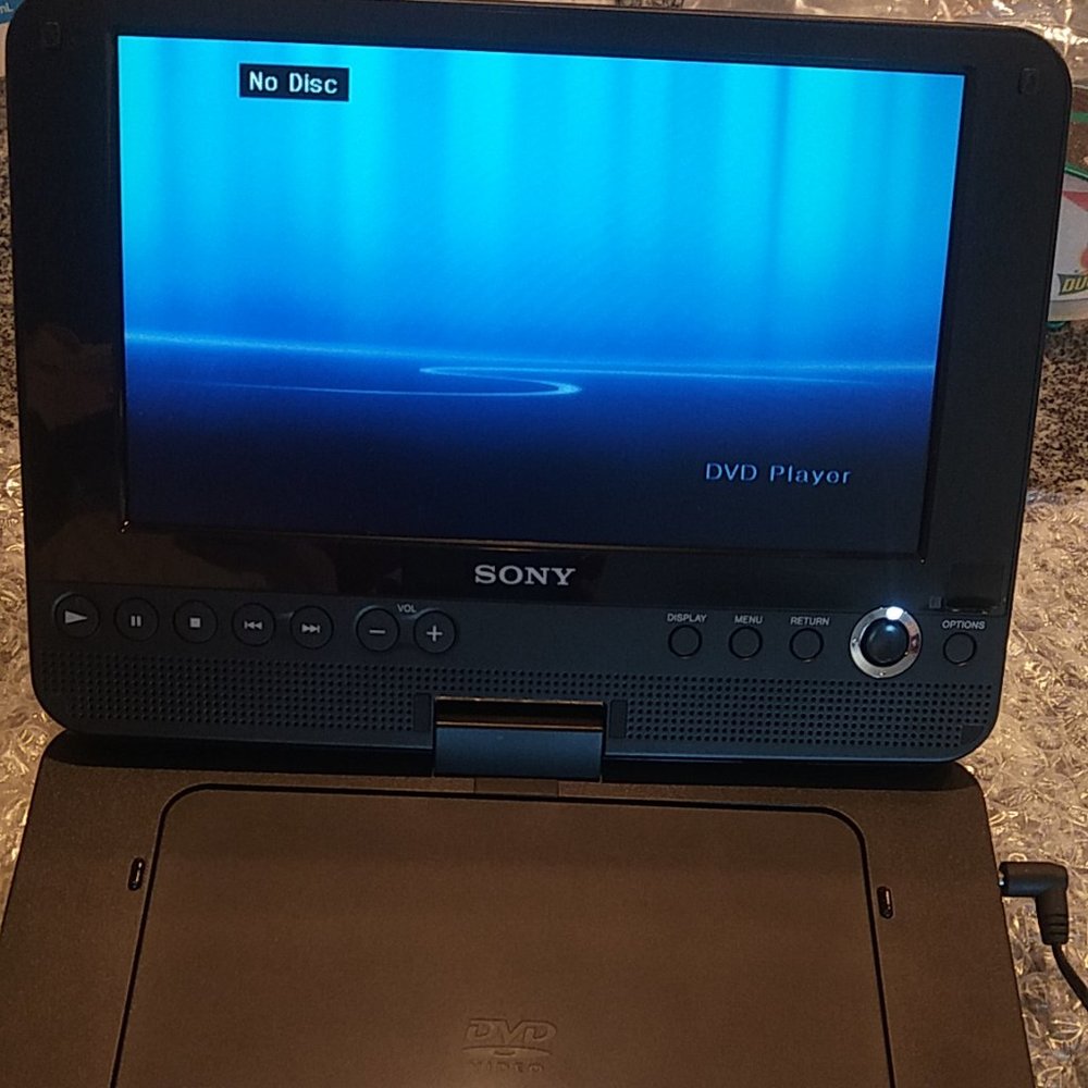 SONY DVP-FX820L Portable DVD Player and power supply.